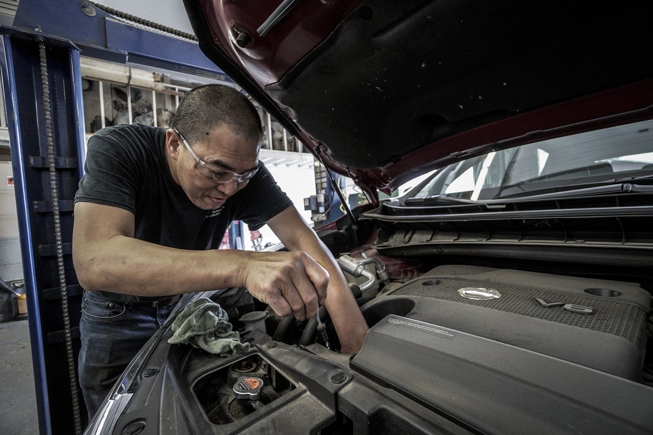 mechanic checking car engine