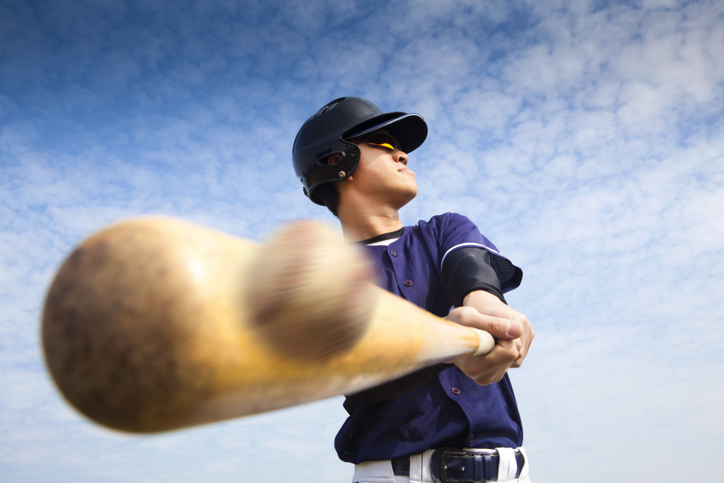 person hitting a baseball