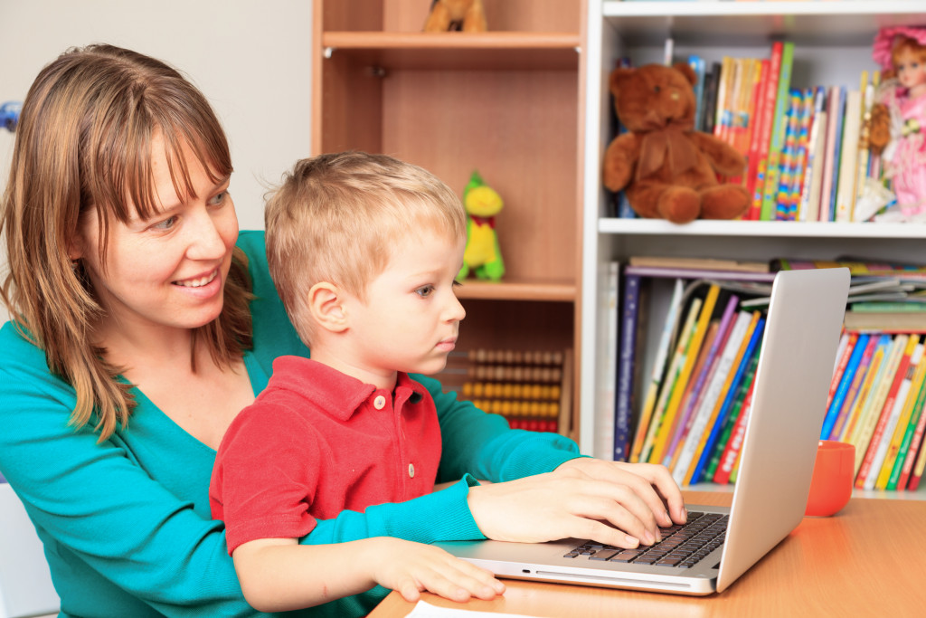 A Little Boy Learning While Mom is Working