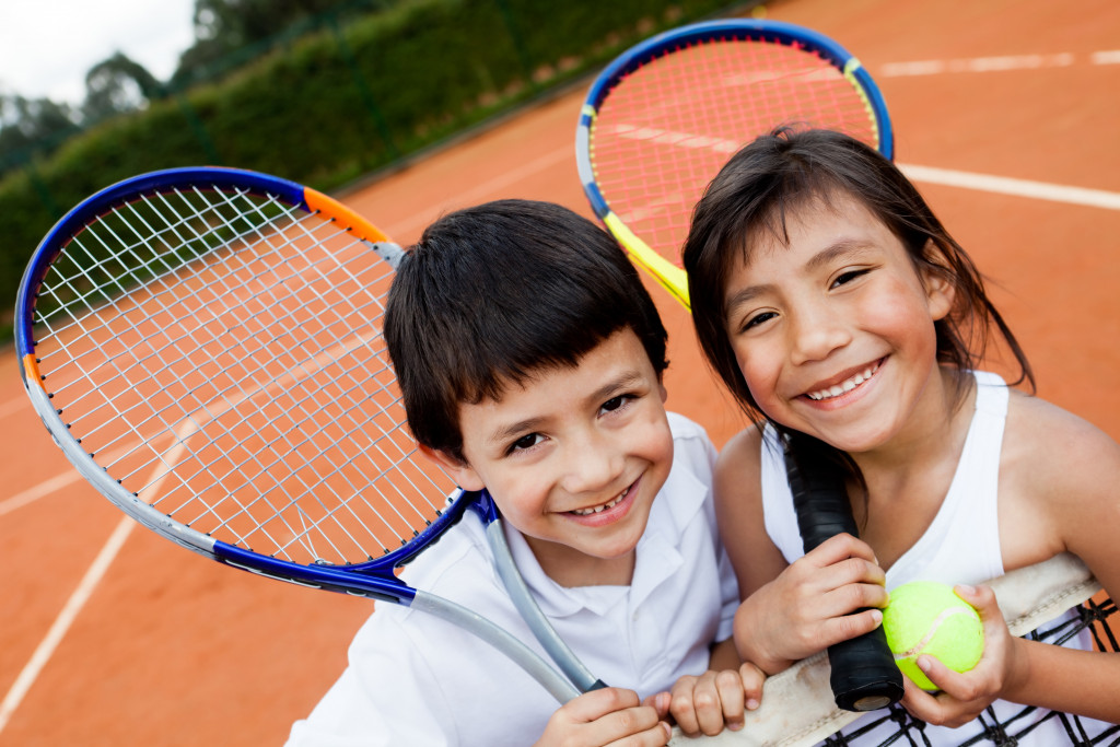 tennis players smiling at the court