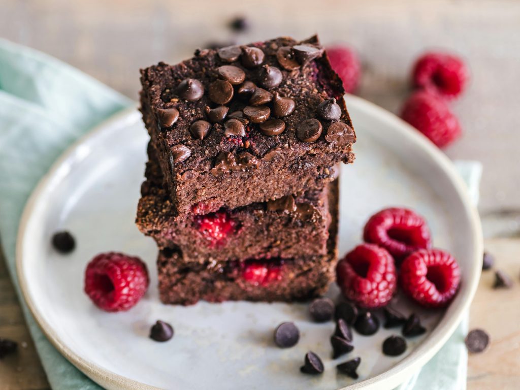 stacked brownies decorated with raspberries