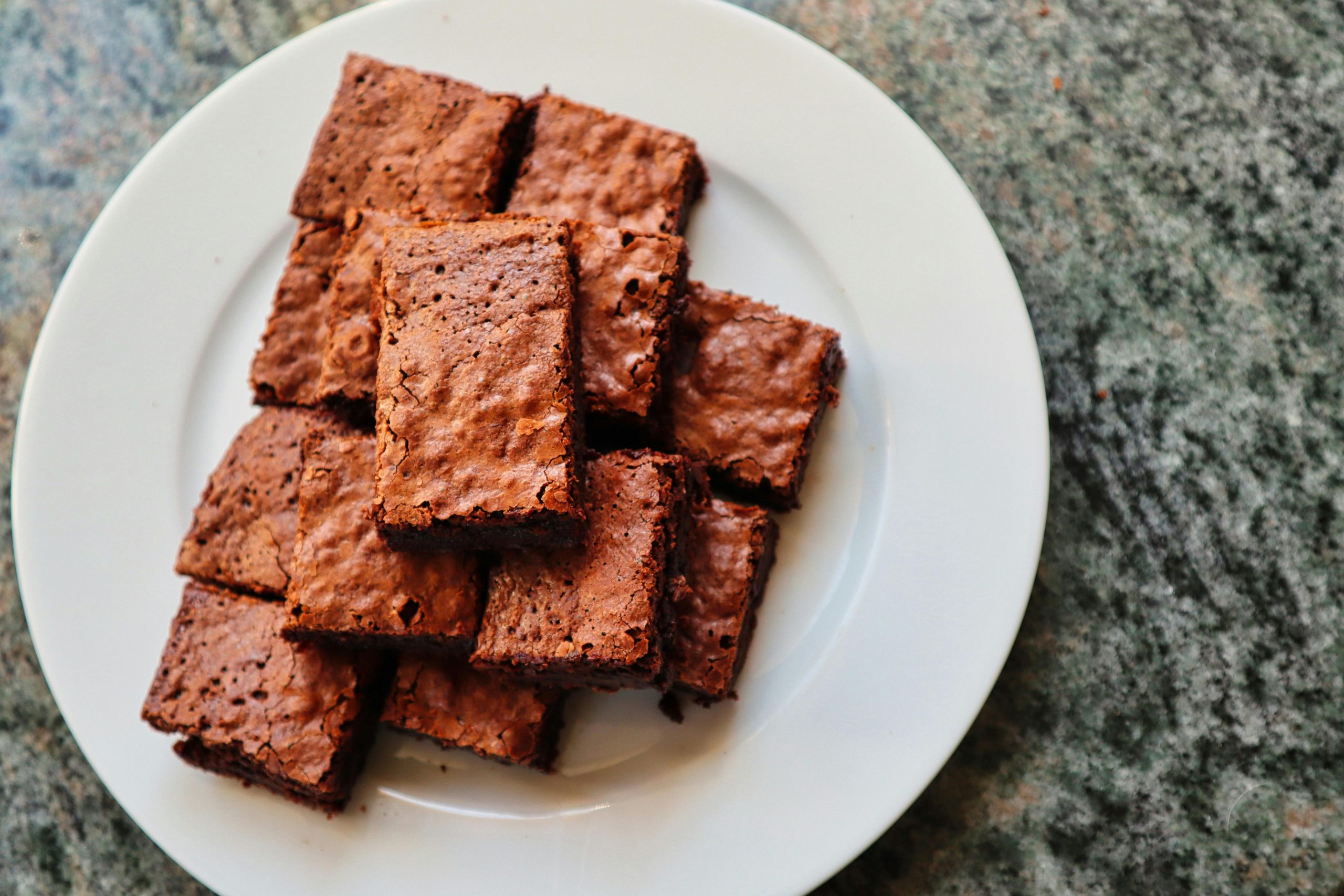 stacked brownies on a ceramic plate